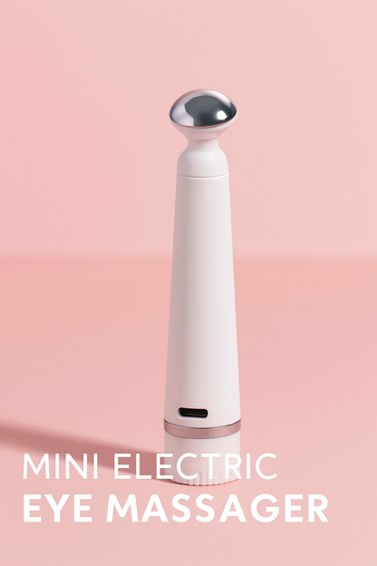 Mini Electric Eye Massager with sleek white body and silver rounded head, designed for reducing puffiness and dark circles around the eyes.