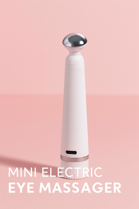 Mini Electric Eye Massager with sleek white body and silver rounded head, designed for reducing puffiness and dark circles around the eyes.